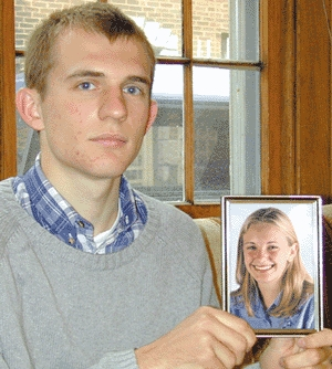 Timothy Woronoff holds up a picture of his alleged Canadian girlfriend.
